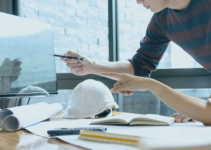 Building contractors working at computer